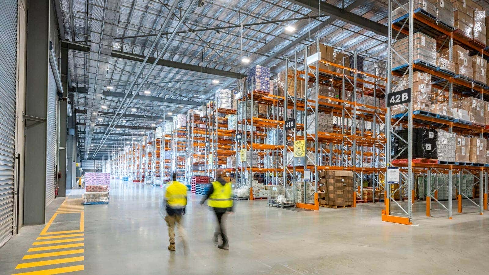 Wielki hub logistyczny z setkami kontenerów i dźwigami na placu przeładunkowym